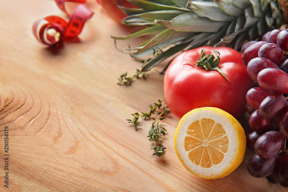 Fresh fruits and tomato on wooden table. Healthy food concept Fresh fruits and tomato on wooden table. Healthy food concept