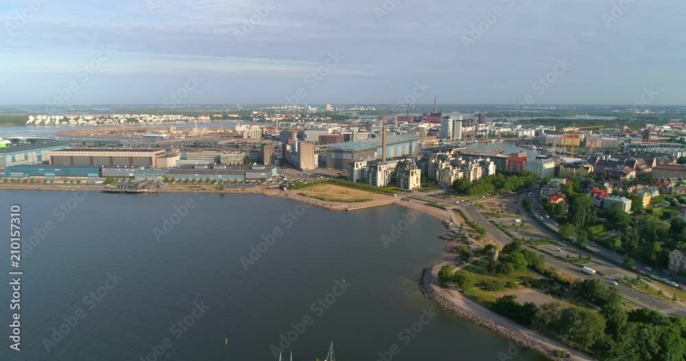 Factory bay, C4k aerial view towards hernesaari island, industry area, on a sunny summer morning dawn, in Helsinki, Uusimaa, Finland Factory bay, C4k aerial view towards hernesaari island, industry area, on a sunny summer morning dawn, in Helsinki, Uusimaa, Finland