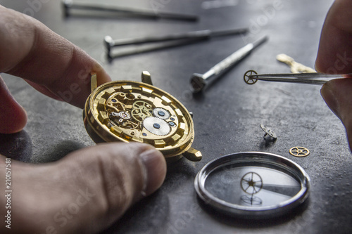 Watchmaker is repairing the mechanical watches in his workshop