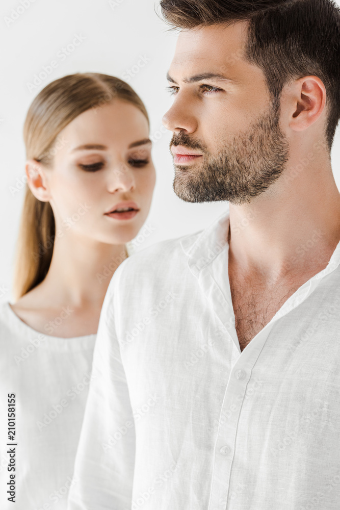 young couple in linen clothes isolated on grey background