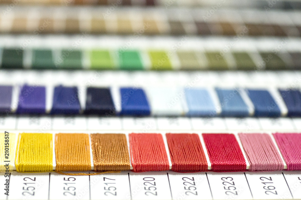 catalog of threads. Multicolored furniture threads. Textile industry background with blurred. Macro, concept of design