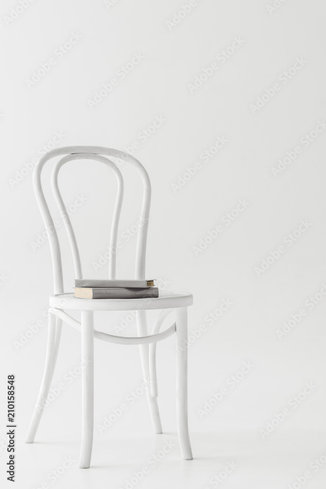 front view of chair with two books isolated on grey background front view of chair with two books isolated on grey background