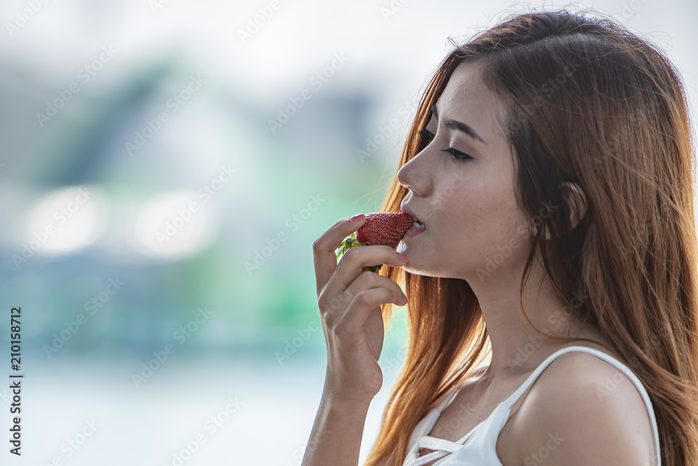 Portrait Asian Sexy woman eating red strawberry, 