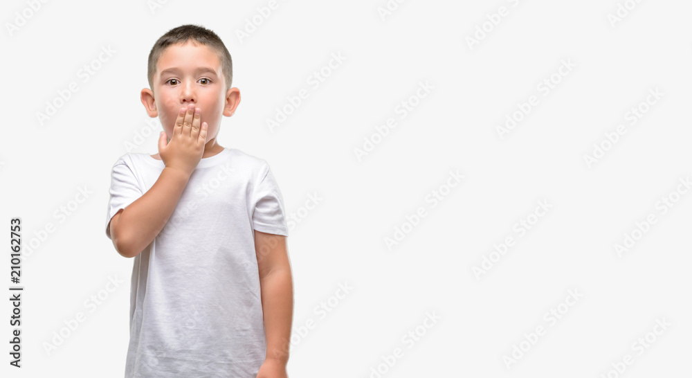 Dark haired little child cover mouth with hand shocked with shame for mistake, expression of fear, scared in silence, secret concept