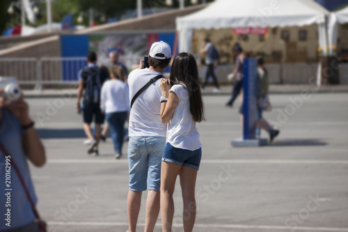 A couple are take off a selfie in a football fan zone