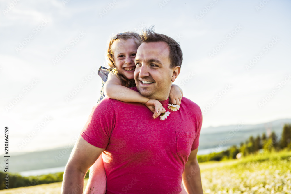 Father spending time with daughter during the sunset.