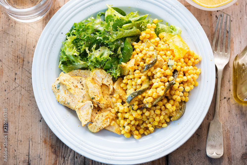 Fiery Moroccan chicken with giant spicy couscous, roasted vegetables and tzatzaki dressing Fiery Moroccan chicken with giant spicy couscous, roasted vegetables and tzatzaki dressing