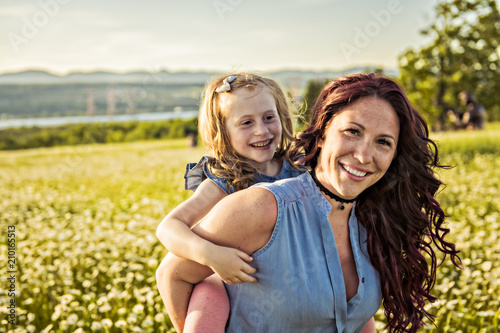 Mother spending time with daughter during the sunset.