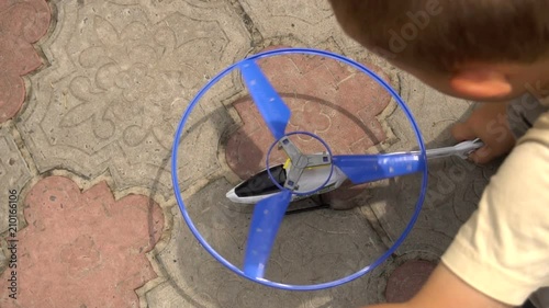 Little Boy Playing With A Toy Helicopter Slow Motion photo