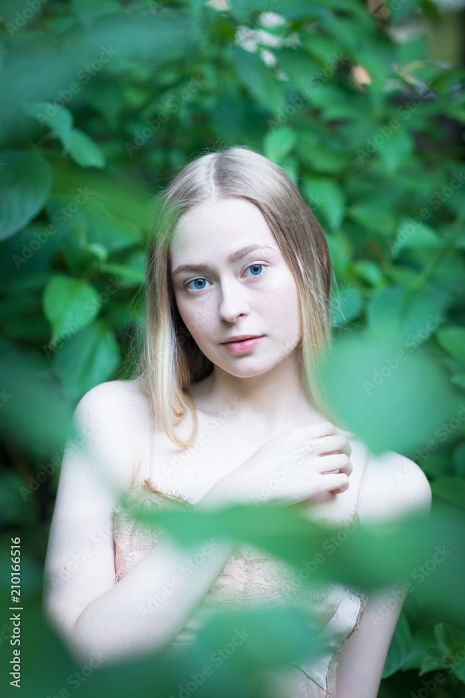 Portrait of young blonde girl in the garden Portrait of young blonde girl in the garden