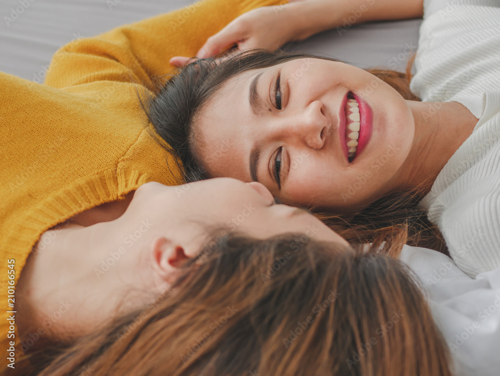 Fototapeta premium Young asian woman lesbian couple smiling happiness on the bed at home. Concept lesbian lifestyle.