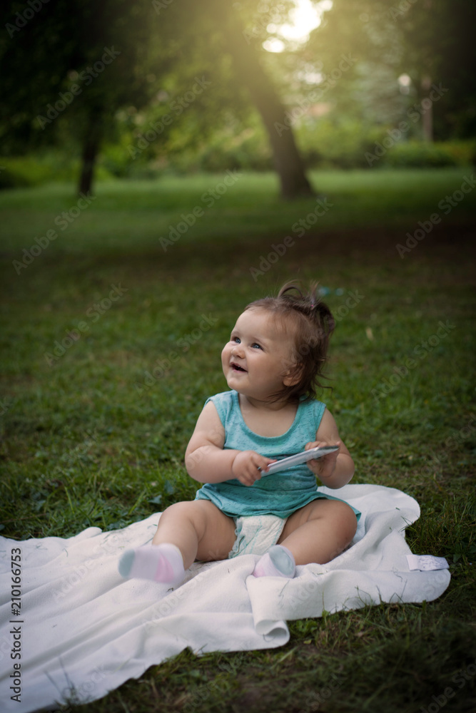 Little girl sitting in the grass. Little girl sitting in the grass.