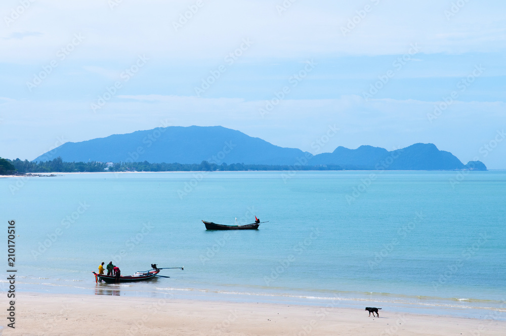 Fototapeta premium Peaceful beach and long tail fishing boat of southern Thailand in Khanom, Nakhon Si Thammarat