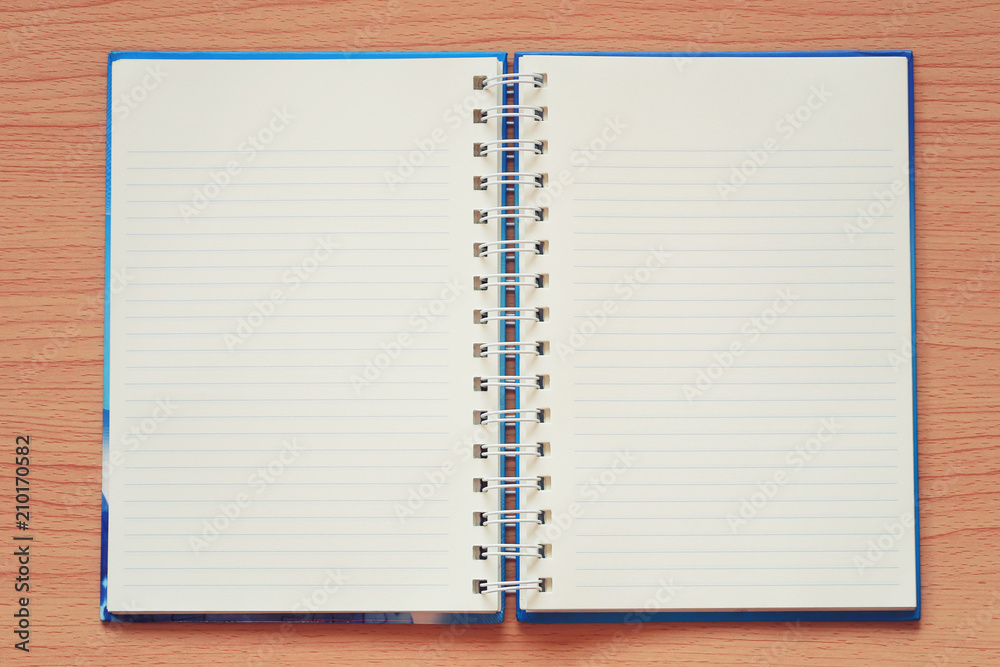 Empty book is placed on a brown wooden background. Empty book is placed on a brown wooden background.