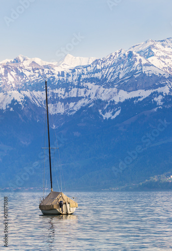 Sailing boats at lake Thun ( Thunersee ) infornt of Alps mountain in the evening photo