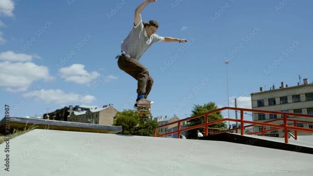Young skater doing tricks outdoors. Slowmotion video 150fps