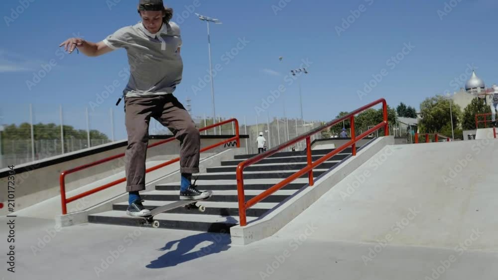 Young skater doing tricks outdoors. Slowmotion video 150fps
