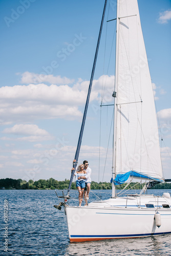 Beautiful young couple hugging while spending time together on yacht © LIGHTFIELD STUDIOS
