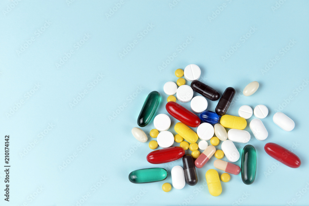 Assorted medicine pills,tablets and capsules on blue background Assorted medicine pills,tablets and capsules on blue background