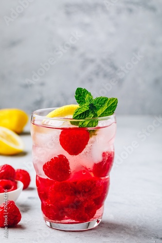 Cold drink Raspberry Lemonade with mint in glass.