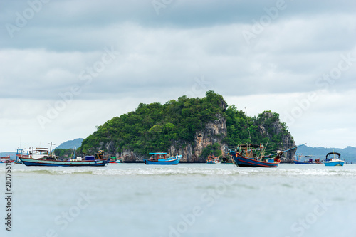 fisherman boat in the sea and cloud pattern with island background