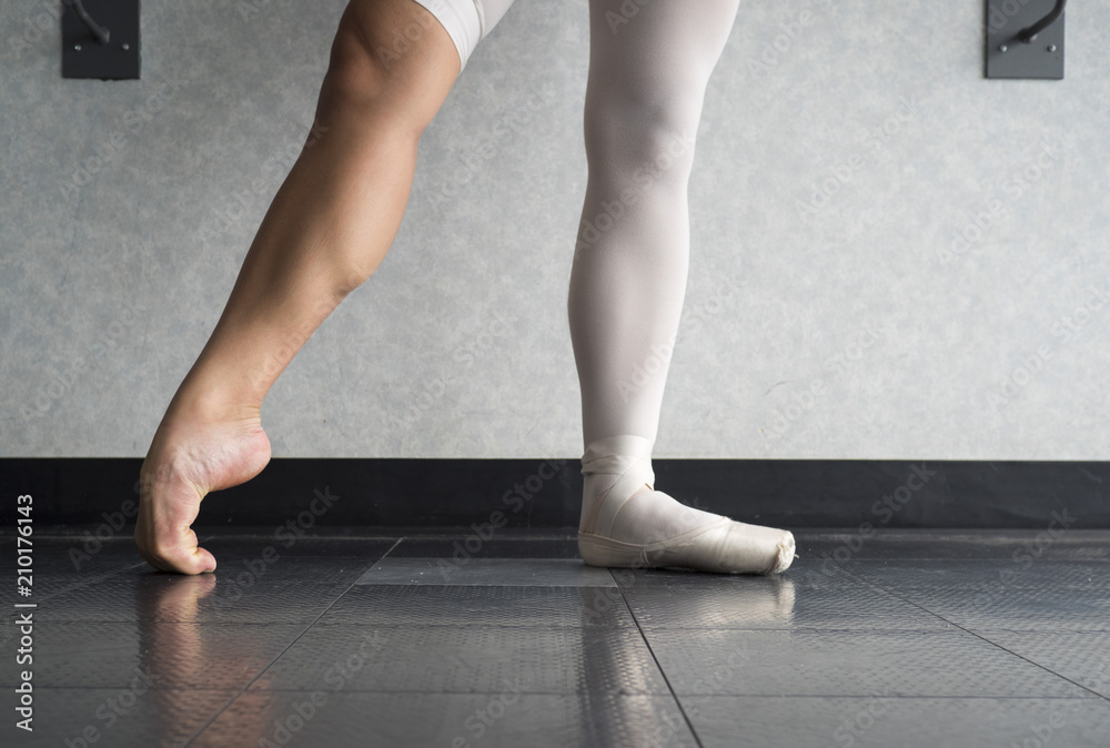 The Hardworking Disciplined Ballerina Ballet Dancer Warming Up In Her  Pointe Shoes And Bare Feet, Displaying The Behind The Scenes Of A Dancer  Stock Photo | Adobe Stock