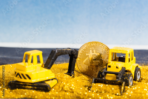 Bitcoin mining with gold glitter and construction vehicles