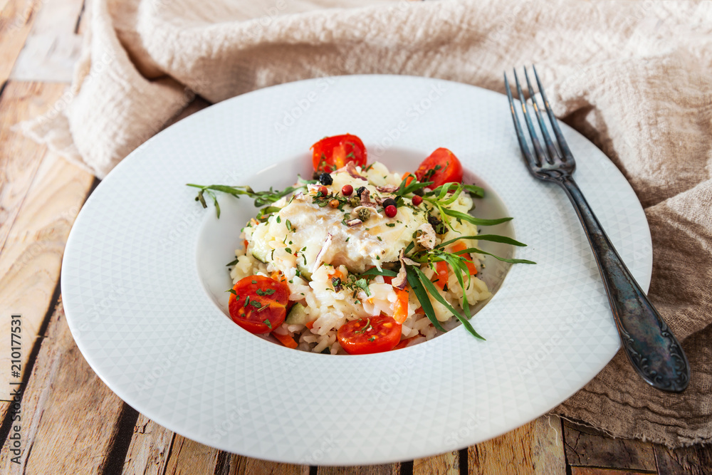Cooked rice with vegetables, cod and lemon sauce Cooked rice with vegetables, cod and lemon sauce