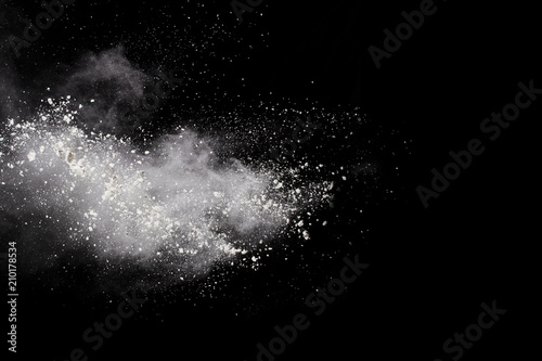 Launched white powder  isolated on black background.