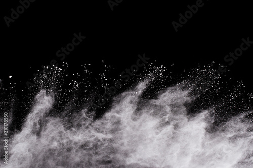 Fototapeta Naklejka Na Ścianę i Meble -  Launched white powder, isolated on black background.