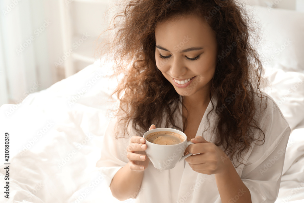 Morning of beautiful African-American woman drinking coffee at home Morning of beautiful African-American woman drinking coffee at home
