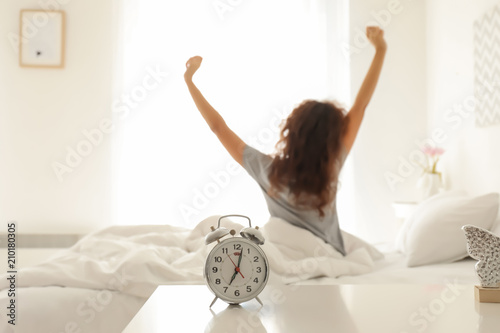 Alarm clock on table in bed...