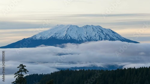 Ultra high definition time lapse video of white moving clouds over snow covered Mt St Helens in Washington state 4k UHD photo