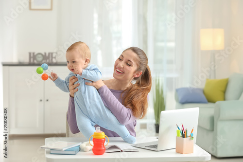 Young mother with baby work...