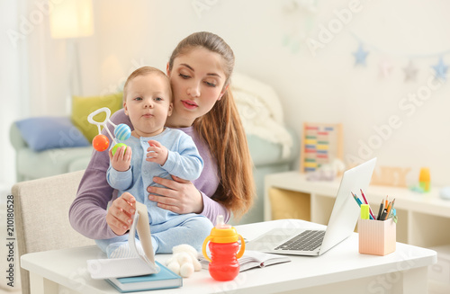 Young mother with baby work...