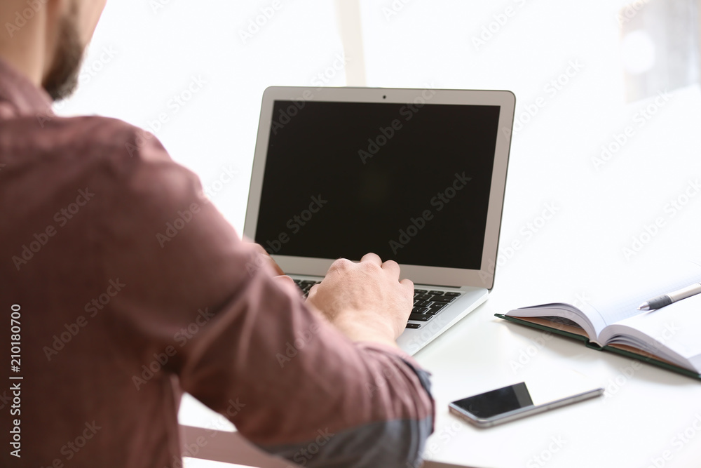 Freelancer working with laptop at home Freelancer working with laptop at home