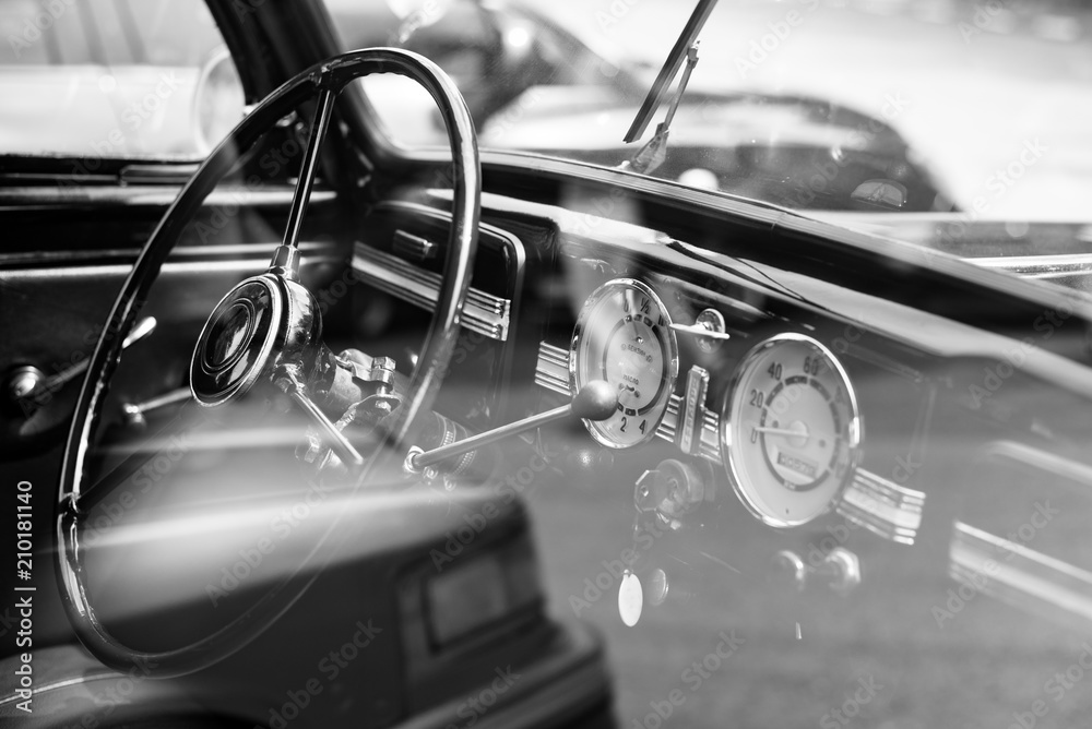 Vintage retro car interior, steering wheel, dashboard, black and white