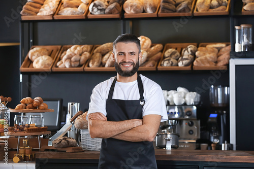 Male baker standing in shop