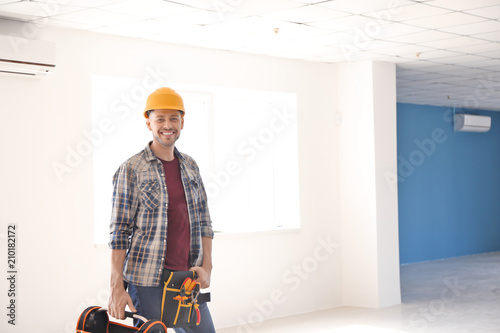 Electrician with toolbox in...