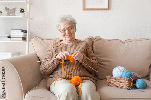 Senior woman sitting on sof...