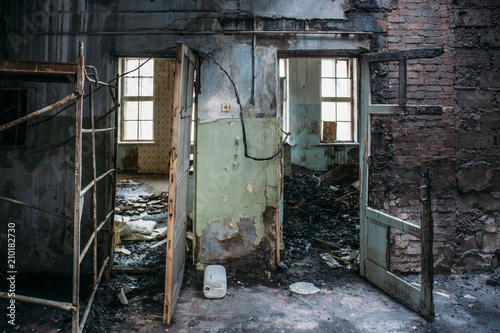 Burned house interior after fire, ruined building room inside, disaster or war aftermath