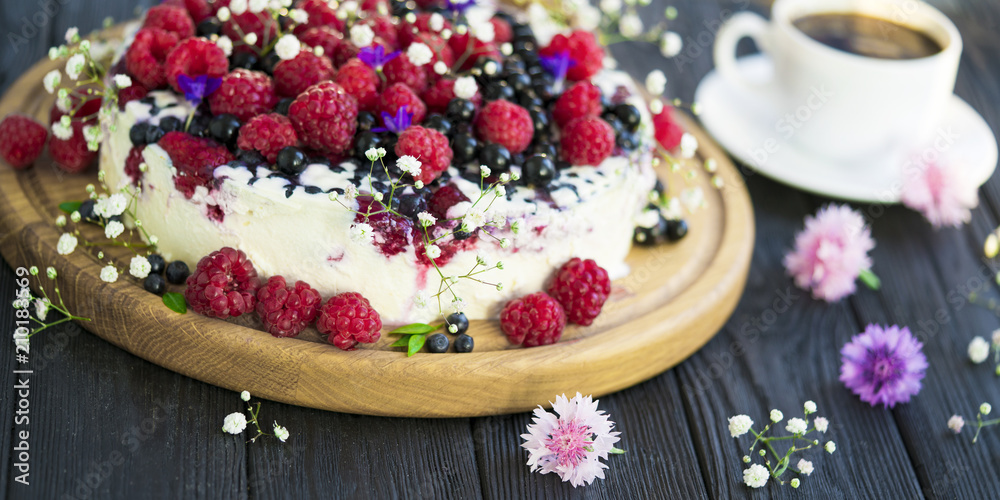 Cheese cake with currant and raspberries on a black background