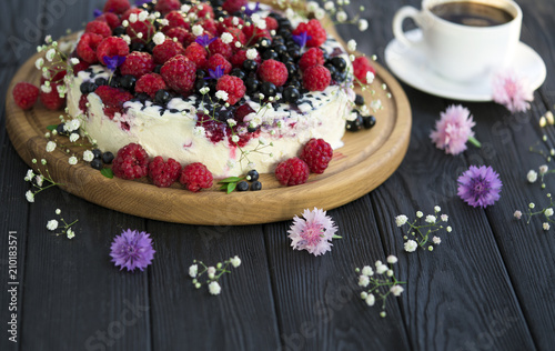 Cheese cake with currant and raspberries on a black background