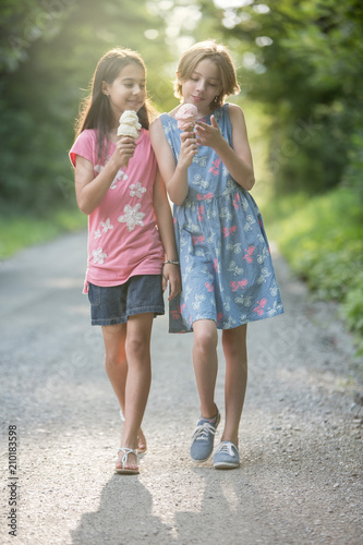 Tween Girl Friends Sharing Ice Cream on a summer day