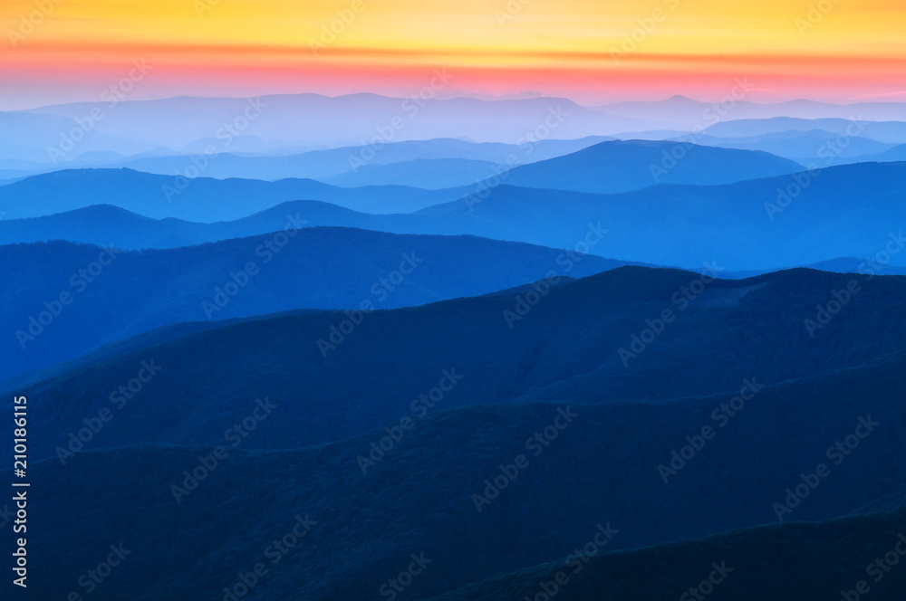 blue range of mountains on sunset