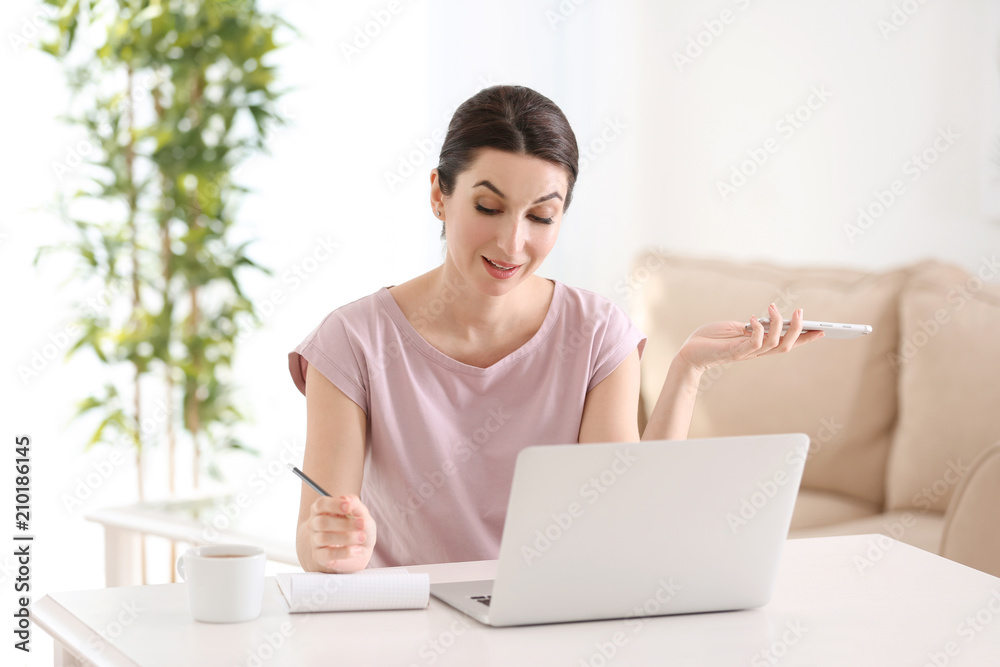 Young female freelancer working with laptop at home Young female freelancer working with laptop at home