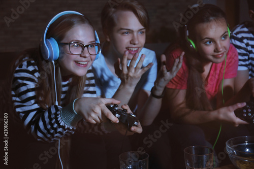 Teenagers playing video gam...