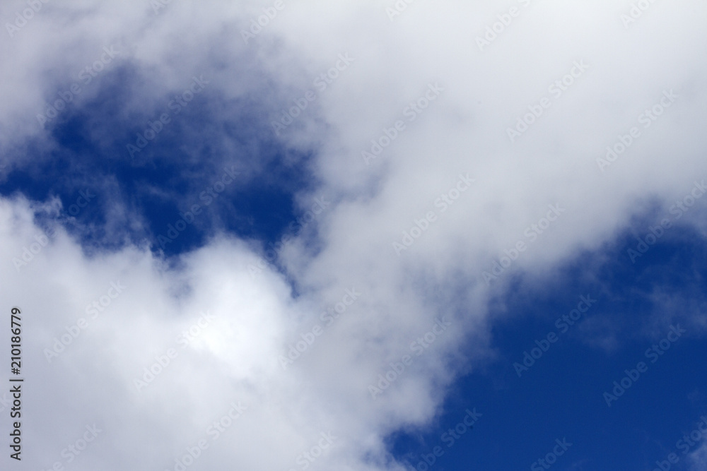 Sky clouds background. Cumulus white clouds in the dark blue sky in the morning