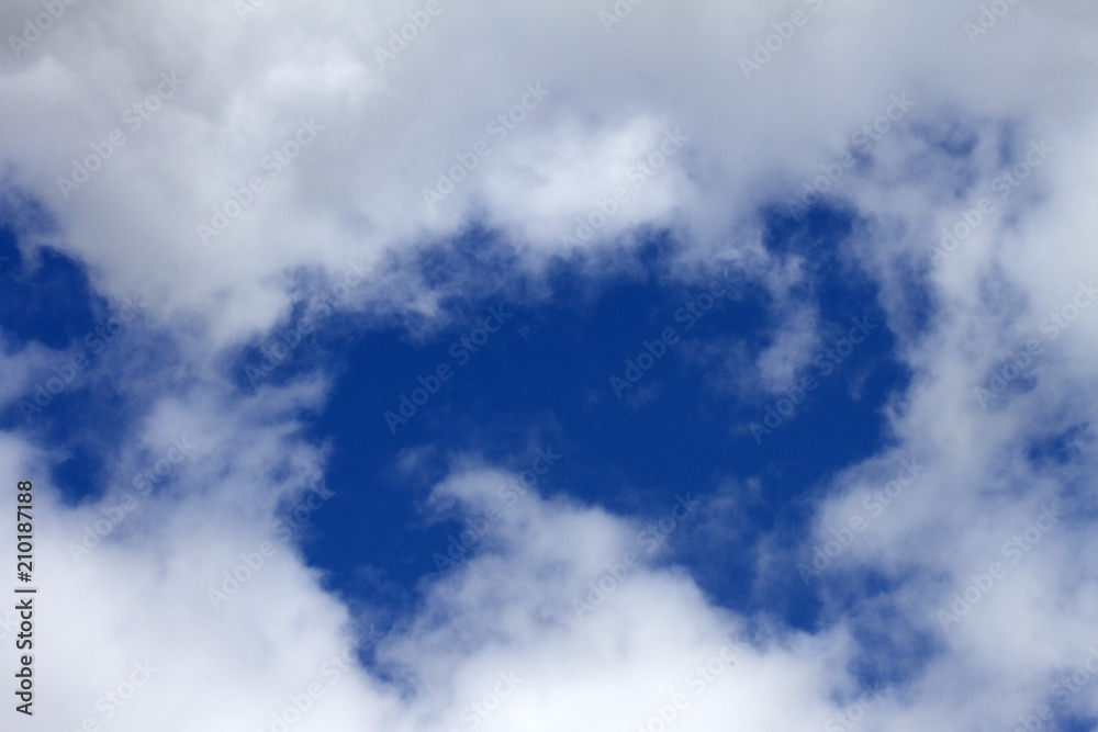 Sky clouds background. Cumulus white clouds in the dark blue sky in the morning