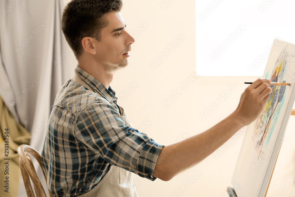 Male student during during classes in school of painters Male student during during classes in school of painters